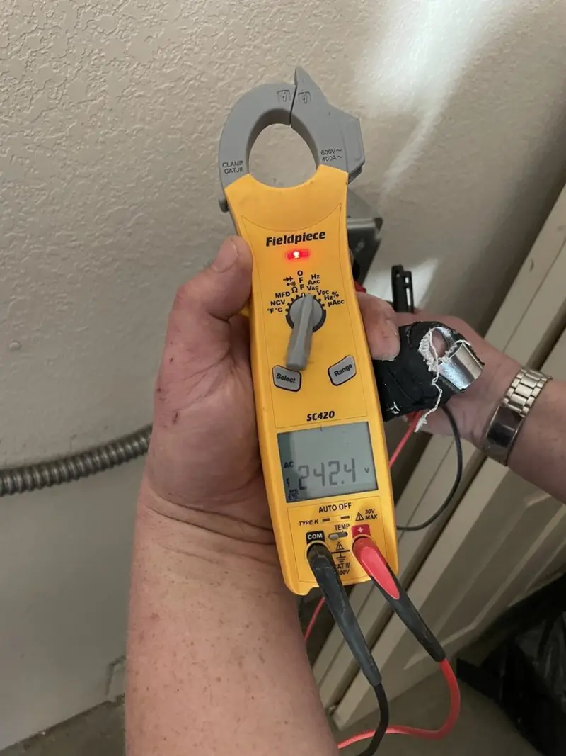 Voltage testing with clamp meter during Ceiling Fan Installation in Royal Pines